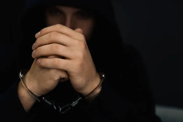 Man detained in handcuffs against dark background. Criminal law — Stock Photo, Image