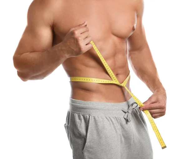 Young man with measuring tape showing his slim body on white background,  closeup Stock Photo by ©NewAfrica 272177214