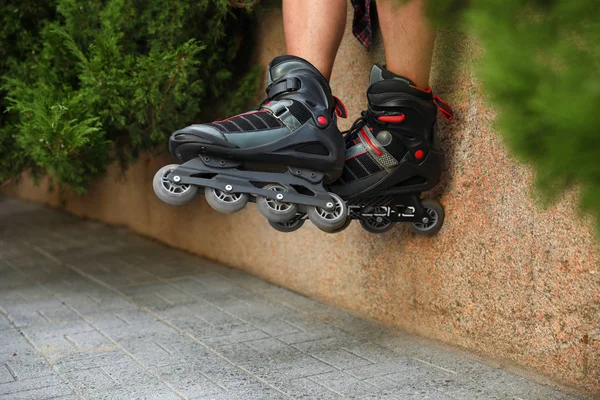 Young man with roller skates outdoors, closeup — Stock Photo, Image