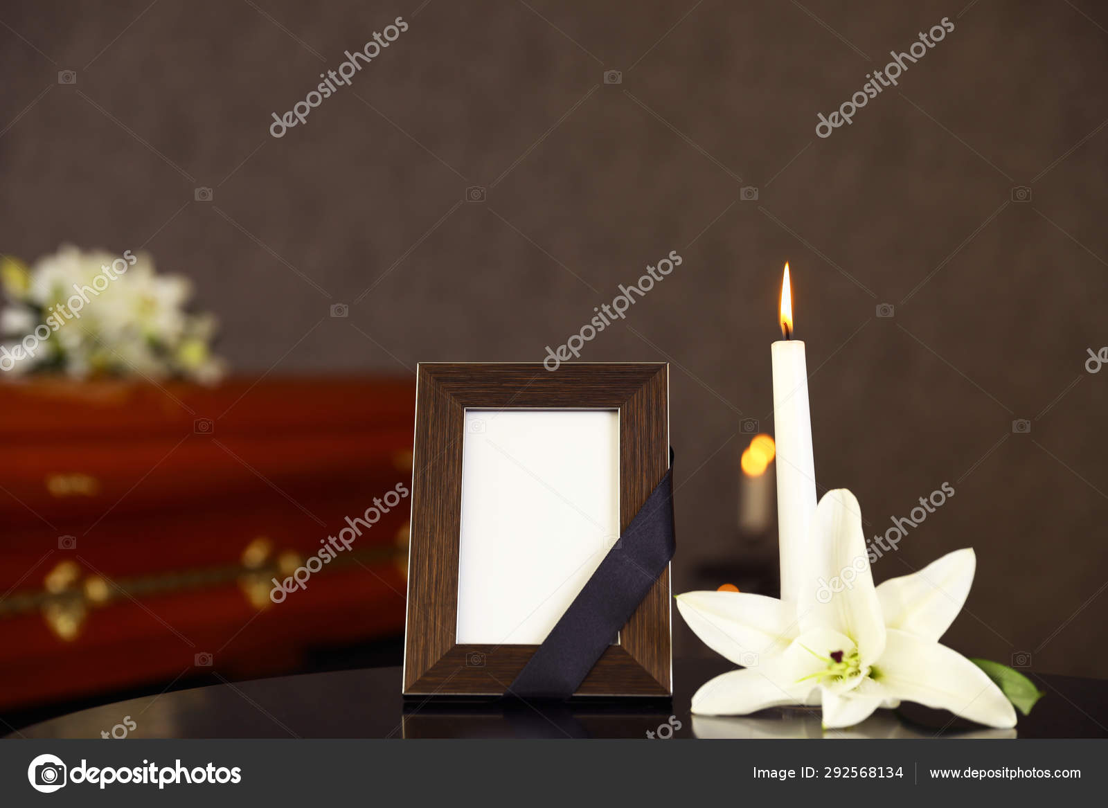 Black Photo Frame With Burning Candle And White Lily On Table In