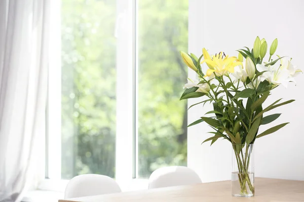 Vase avec bouquet de beaux lis sur table en bois à l'intérieur. Espace pour le texte — Photo