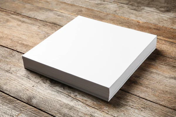 Stack of blank paper sheets for brochure on wooden background. Mock up — Stock Photo, Image
