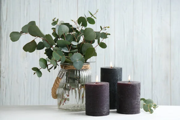 Queimando velas e ramos verdes na mesa branca — Fotografia de Stock