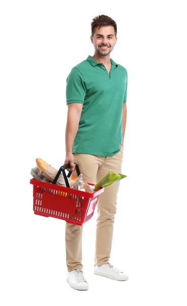 Jovem com cesta cheia de produtos isolados em branco — Fotografia de Stock