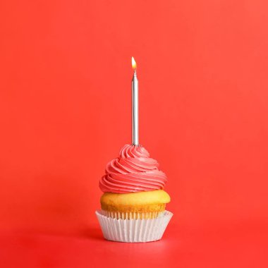 Kırmızı arka plan üzerinde mum ile Doğum günü cupcake
