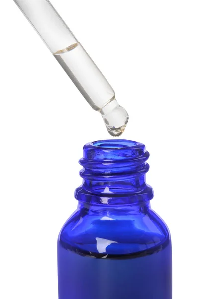 Blauwe fles en druppelaar met etherische olie op witte achtergrond — Stockfoto
