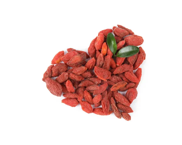 Heart shaped pile of dried goji berries with leaves on white background, top view — Stock Photo, Image
