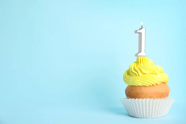 Birthday cupcake with number one candle on blue background, space for text — Stock Photo, Image