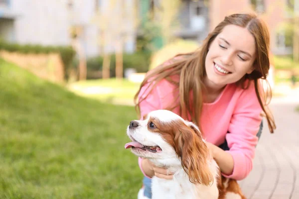 Young woman with adorable Cavalier King Charles Spaniel dog outdoors — Stock Photo, Image