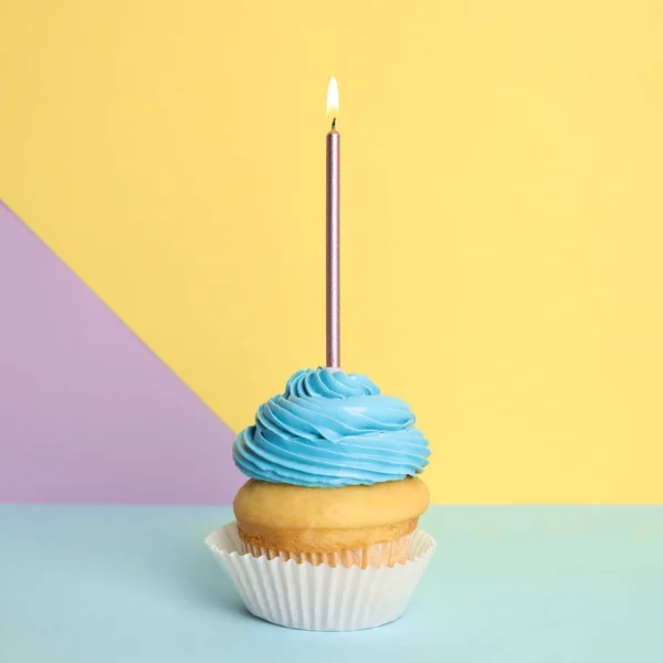 Geburtstagskuchen mit Kerze auf farbigem Hintergrund — Stockfoto