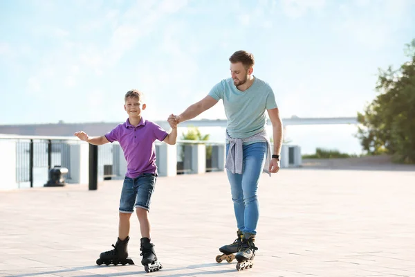 Pai e filho patinagem na rua da cidade — Fotografia de Stock