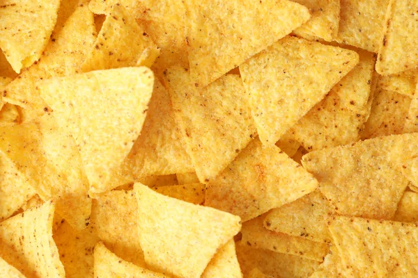 Tasty Mexican nachos chips as background, top view — Stock Photo, Image