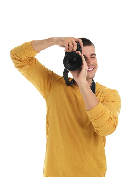 Young professional photographer taking picture on white background — Stock Photo, Image