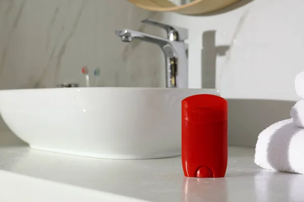 Deodorant container on light countertop in bathroom — Stock Photo, Image