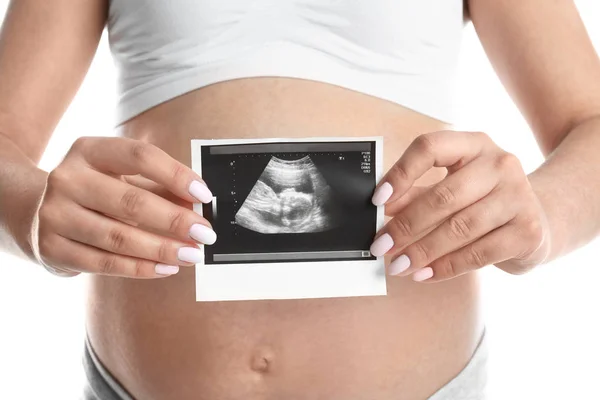 Pregnant woman with ultrasound picture on white background, closeup — Stock Photo, Image