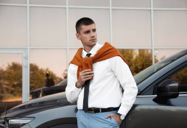 Çekici genç adam yakın lüks araba açık havada