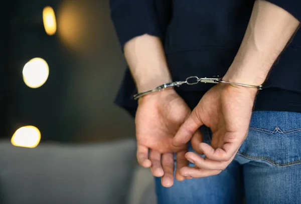 Man detained in handcuffs indoors, space for text. Criminal law — Stock Photo, Image