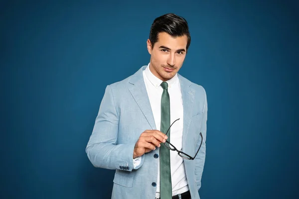 Retrato de joven guapo en traje sobre fondo azul —  Fotos de Stock