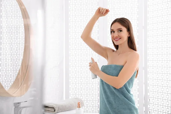 Mooie jonge vrouw toepassen deodorant na douche in de badkamer — Stockfoto