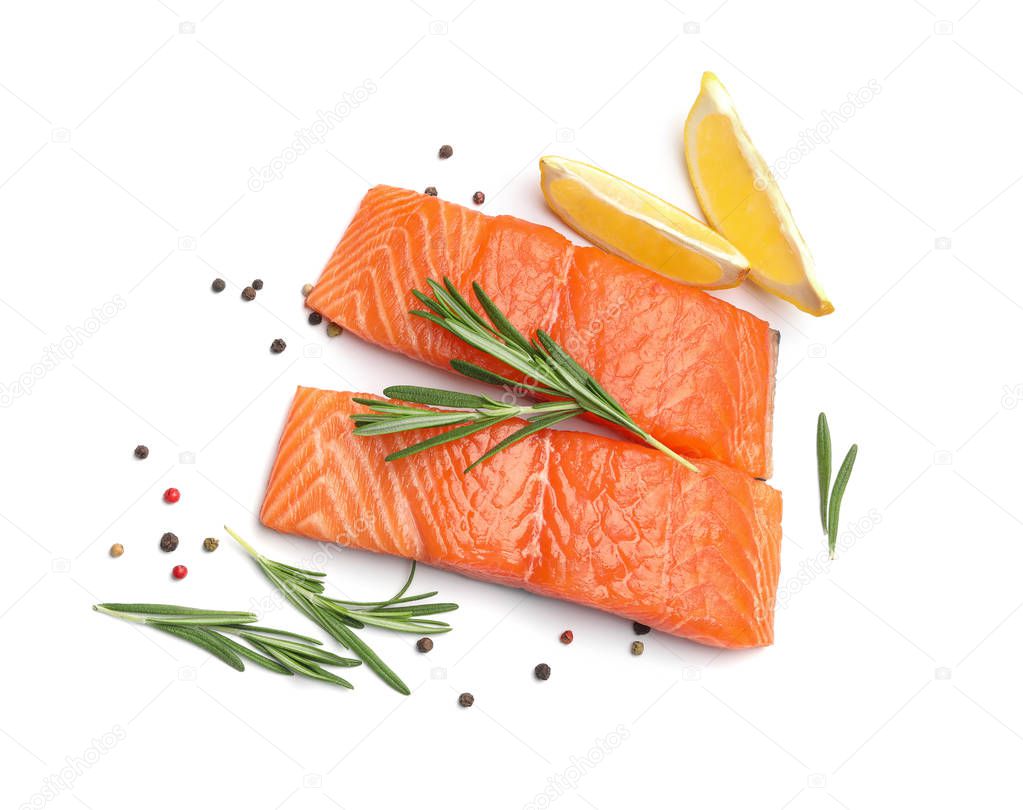 Fresh raw salmon fillets with rosemary and lemon on white background, top view