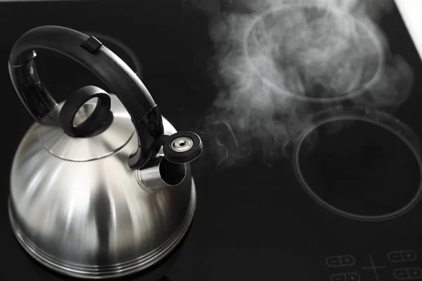 Modern kettle with whistle on stove, above view. Space for text — Stock Photo, Image