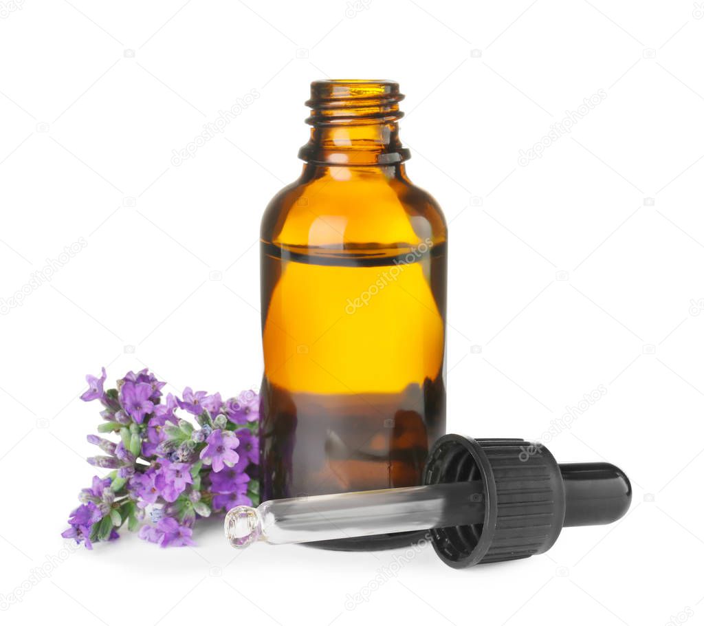 Bottle of essential oil and lavender flowers isolated on white