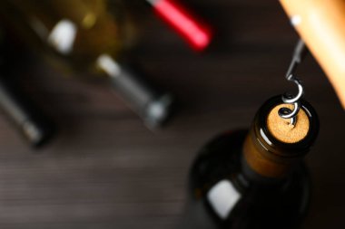 Bulanık arka planda şarap ve tirbuşon şişesi, metin için alan