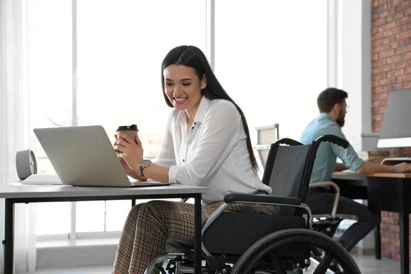 職場でノートパソコンを使用して車椅子の若い女性 — ストック写真