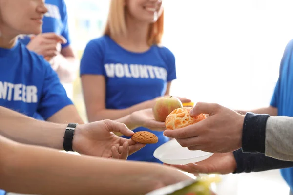 Volunteers serving food to poor people, closeup — Stock Photo, Image