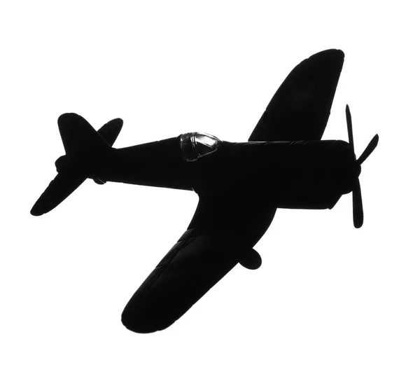 Темный силуэт винтажной игрушки военного самолета на белом фоне — стоковое фото
