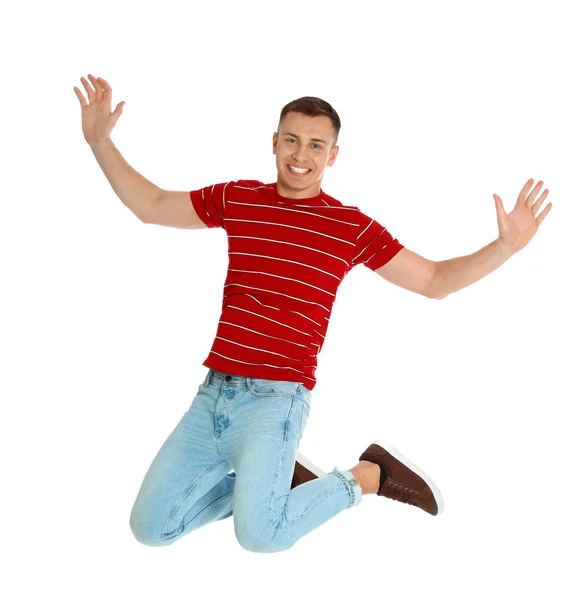 Щасливий молодий чоловік стрибає на білому тлі — стокове фото