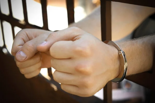 Man handcuffed in jail outdoors, closeup. Criminal law — Stock Photo, Image