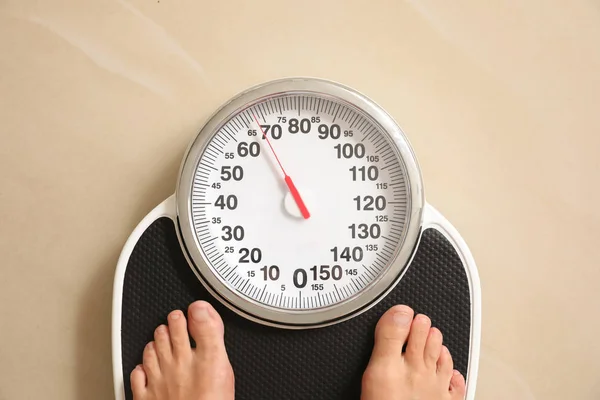 Woman standing on floor scales indoors, top view. Overweight problem — Stock Photo, Image