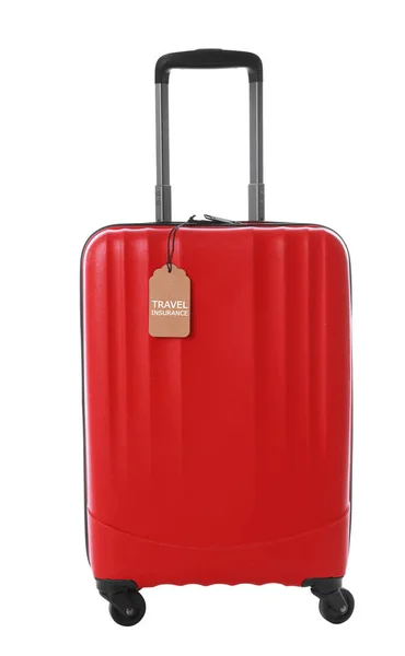Roter Koffer mit Reiseversicherungsetikett auf weißem Hintergrund — Stockfoto