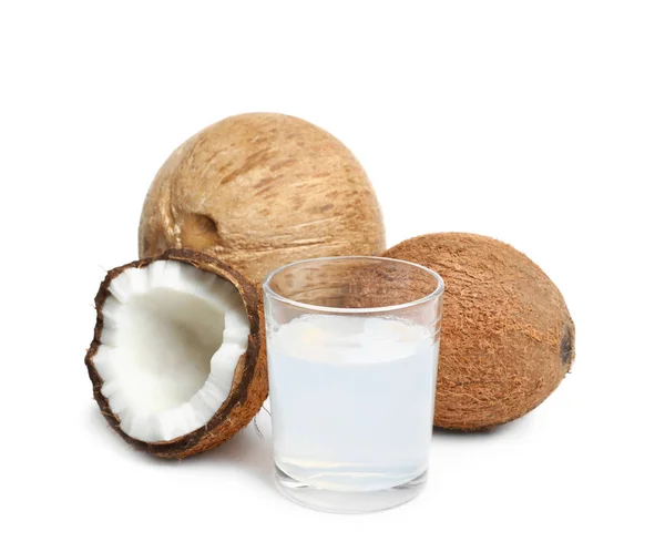 Glass of coconut milk and nuts on white background — Stock Photo, Image