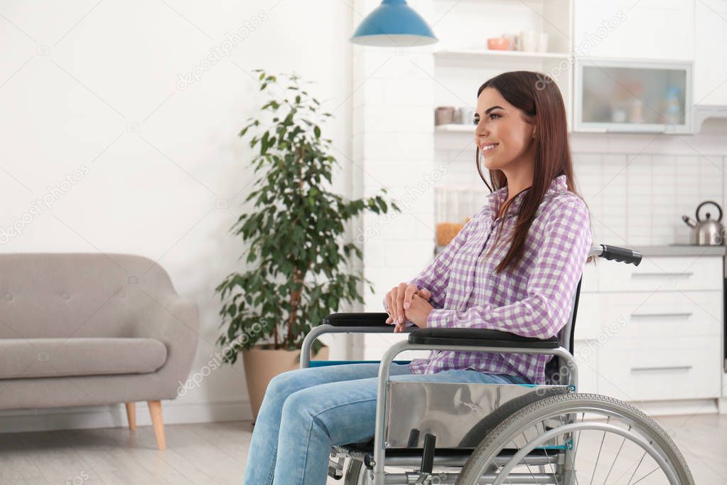 Young woman sitting in modern wheelchair indoors