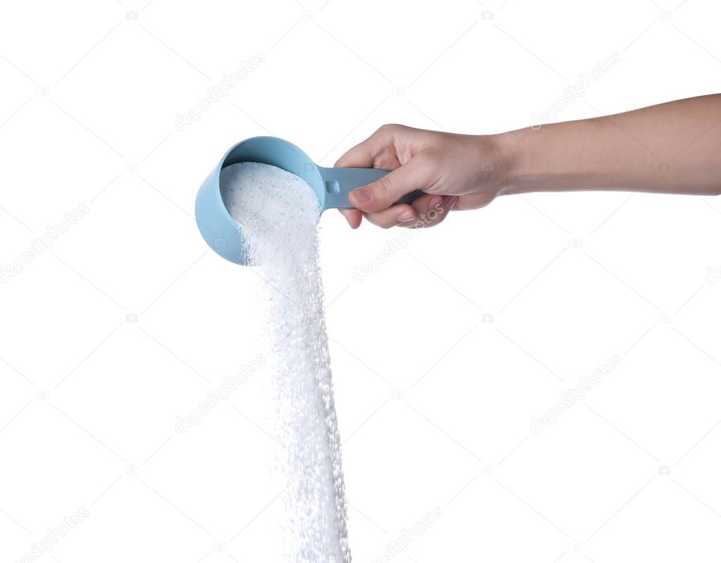 Woman pouring laundry detergent from measuring container against white background, closeup