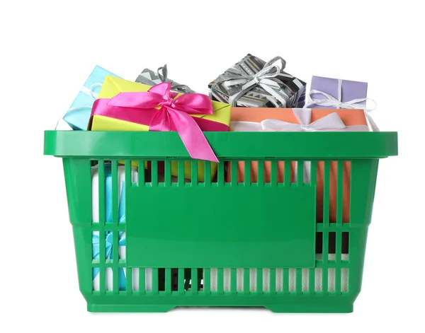 Green shopping basket with different gifts on white background — Stock Photo, Image