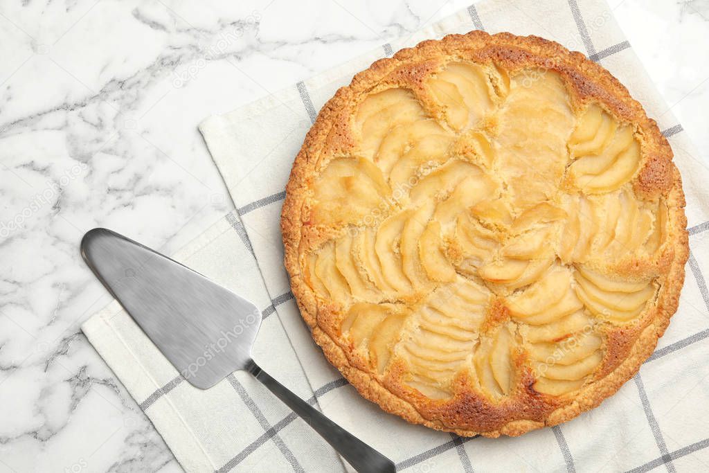 Delicious sweet pear tart with spatula on white marble table, flat lay