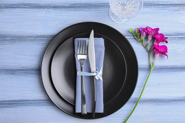 Snygg och elegant bords miljö med freesia på blå trä bakgrund, topputsikt — Stockfoto