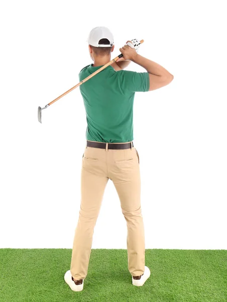 Young man playing golf on course against white background — Stock Photo, Image