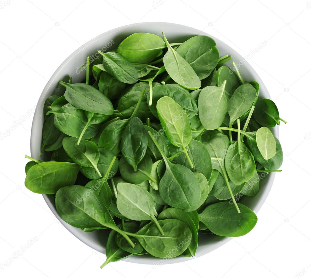 Bowl of fresh green healthy baby spinach on white background, top view