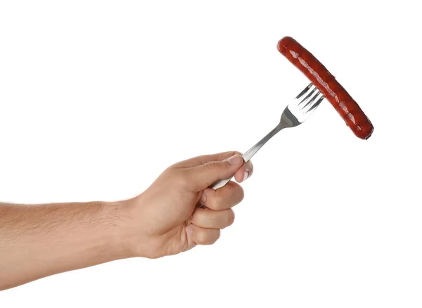 Uomo che tiene la forchetta con salsiccia alla griglia su sfondo bianco, primo piano. Cibo barbecue — Foto Stock