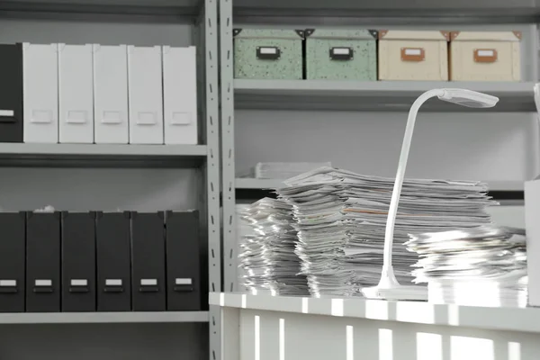 Stacks of documents on table in office