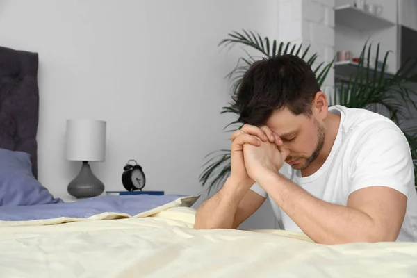 Handsome man saying bedtime prayer at home. Space for text — Stock Photo, Image