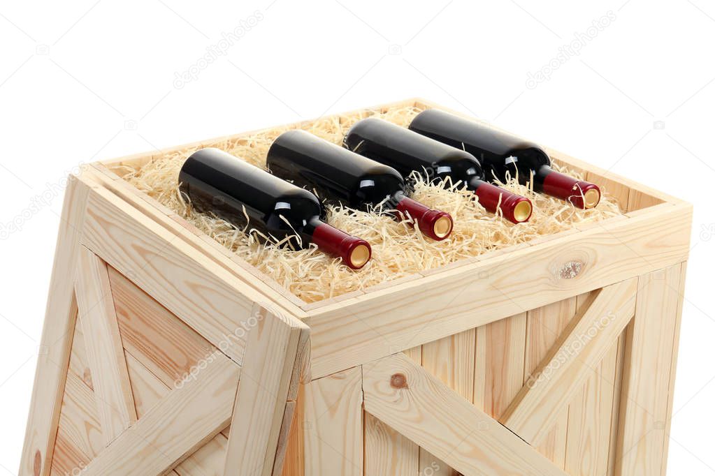 Bottles of wine in open wooden crate isolated on white