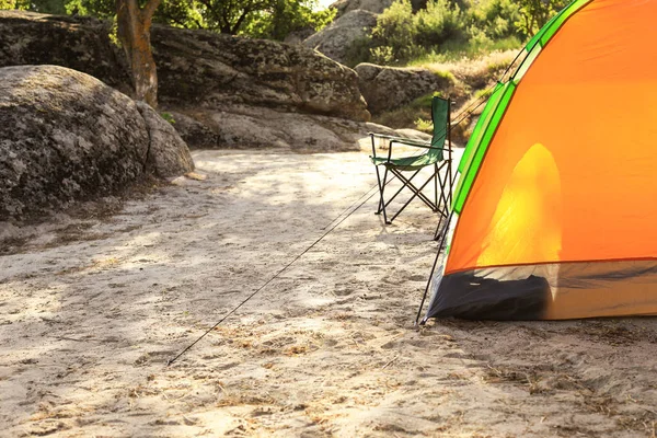 Moderna tenda da campeggio e sedia nella natura selvaggia. Spazio per testo — Foto Stock