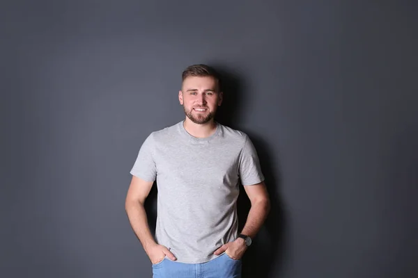 Portrait of handsome happy man on grey background — Stock Photo, Image