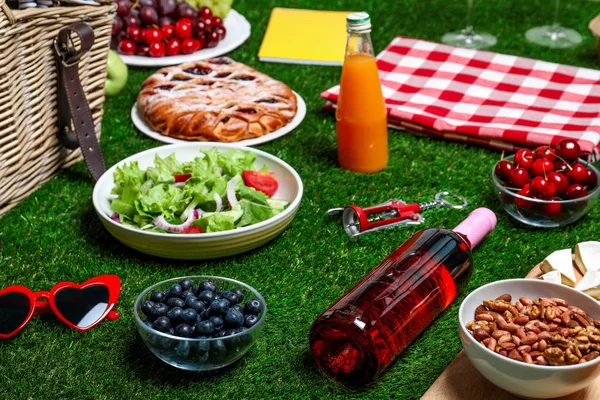 Many different products on green grass. Summer picnic — Stock Photo, Image