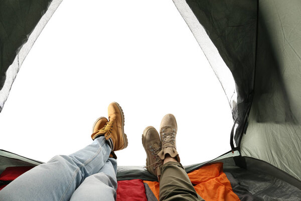 Closeup of couple in camping tent on white background, view from inside